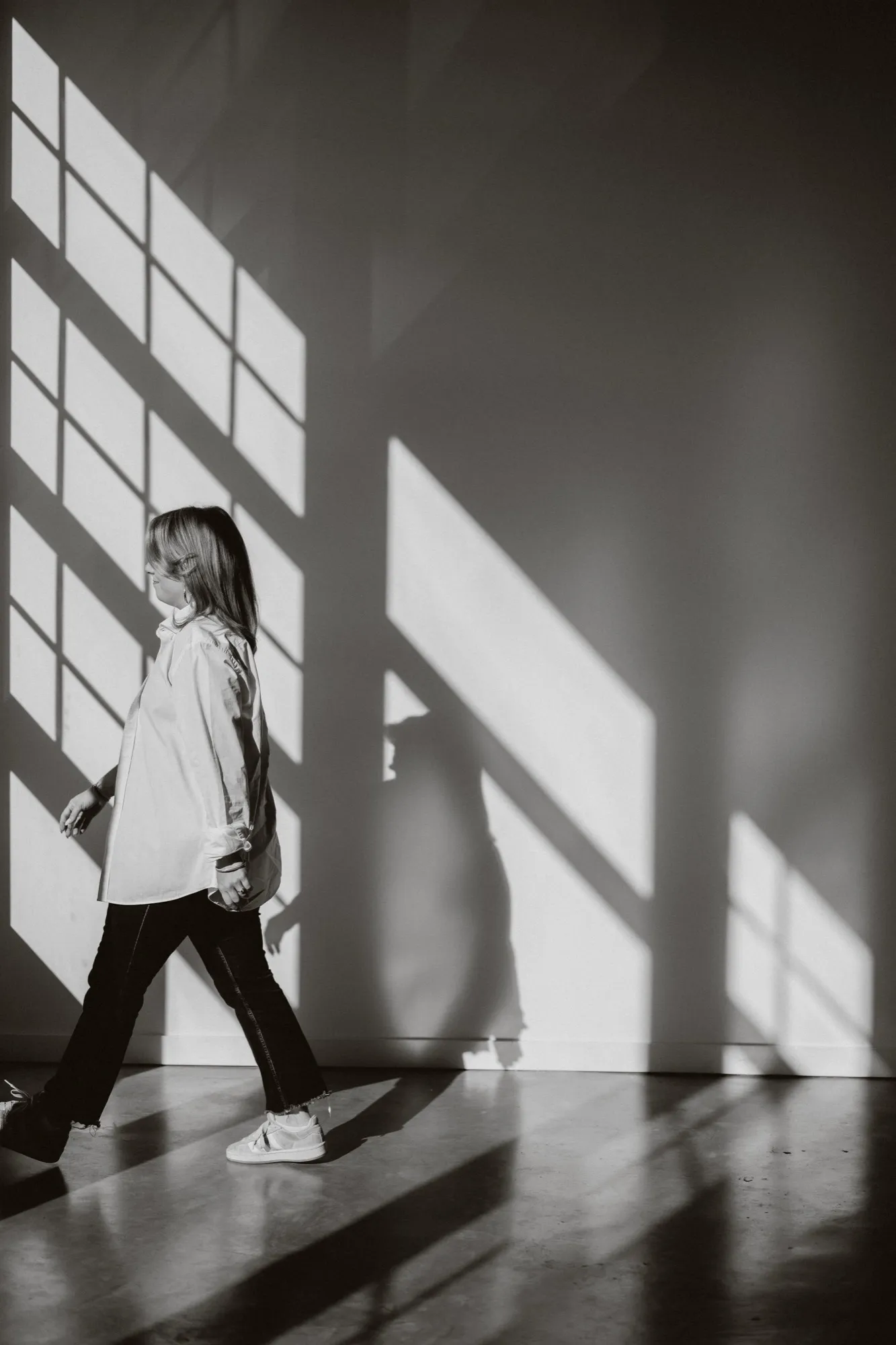 Clémence Tillerot walking through a sunlit studio