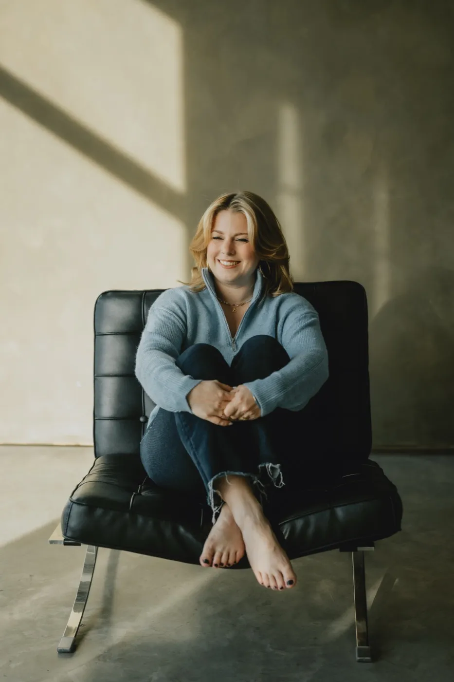 Clémence Tillerot smiling in a black armchair
